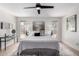 Bright main bedroom featuring a ceiling fan, large windows, and stylish decor at 5211 E Winchcomb Dr, Scottsdale, AZ 85254