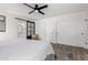 Bright main bedroom featuring a ceiling fan, ensuite bathroom, and spacious closets at 5211 E Winchcomb Dr, Scottsdale, AZ 85254