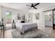 Bright main bedroom featuring a ceiling fan, ensuite bathroom, and modern decor at 5211 E Winchcomb Dr, Scottsdale, AZ 85254