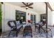 Comfortable covered patio with wicker furniture, ceiling fan, and outdoor grill, perfect for relaxing and entertaining at 5211 E Winchcomb Dr, Scottsdale, AZ 85254