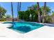 Inviting backyard pool with lush landscaping, tall palm trees, and a serene ambiance for ultimate relaxation at 5211 E Winchcomb Dr, Scottsdale, AZ 85254