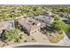 Expansive aerial view of a luxurious home with a tile roof, solar panels, and manicured landscaping at 5243 E Windstone Trl, Cave Creek, AZ 85331