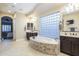 A bathroom with dual sinks, decorative tile, a large vanity, and a large tub at 5243 E Windstone Trl, Cave Creek, AZ 85331