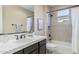 Well-lit bathroom featuring a shower over tub, tiled walls, single sink vanity and a framed mirror at 5243 E Windstone Trl, Cave Creek, AZ 85331