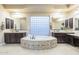 A bathroom with dual sinks, decorative tile, a large vanity, and a large tub at 5243 E Windstone Trl, Cave Creek, AZ 85331