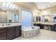 A bathroom with dual sinks, decorative tile, a large vanity, and a large tub at 5243 E Windstone Trl, Cave Creek, AZ 85331