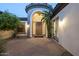 Elegant entrance featuring a rustic door, arched entryway, and decorative wall sconces for warm lighting at 5243 E Windstone Trl, Cave Creek, AZ 85331