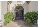 Charming entryway with wrought iron gate, a brick walkway, and mature landscaping for added privacy at 5243 E Windstone Trl, Cave Creek, AZ 85331