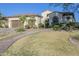 Lush front lawn with desert landscaping, mature trees and a two-car garage at 5243 E Windstone Trl, Cave Creek, AZ 85331