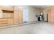 Functional garage with built-in cabinets, water heater, and coated concrete flooring perfect for storage and projects at 5243 E Windstone Trl, Cave Creek, AZ 85331