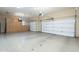 Spacious garage with built-in storage cabinets, featuring two garage doors and sealed concrete flooring at 5243 E Windstone Trl, Cave Creek, AZ 85331