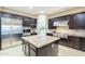 Gourmet kitchen with stainless steel appliances, granite island and dark wood cabinets at 5243 E Windstone Trl, Cave Creek, AZ 85331
