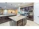 Spacious kitchen island with granite countertop and dark wood cabinetry with stainless steel appliances at 5243 E Windstone Trl, Cave Creek, AZ 85331