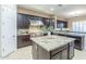 Well-appointed kitchen featuring dark wood cabinets, a granite island, and stainless steel appliances at 5243 E Windstone Trl, Cave Creek, AZ 85331