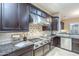 Close up of a professional grade stainless steel range and hood, in a kitchen with granite countertops at 5243 E Windstone Trl, Cave Creek, AZ 85331