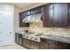 Detailed kitchen view with a stainless steel range, granite countertops, and dark wood cabinetry at 5243 E Windstone Trl, Cave Creek, AZ 85331
