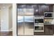 This kitchen offers built-in stainless steel appliances and abundant dark wood cabinets at 5243 E Windstone Trl, Cave Creek, AZ 85331