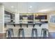Spacious kitchen with dark wood cabinets, granite counters, stainless appliances, and pendant lighting at 5243 E Windstone Trl, Cave Creek, AZ 85331