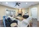 Inviting living room featuring a stone fireplace, plush seating, and abundant natural light at 5243 E Windstone Trl, Cave Creek, AZ 85331