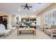 Sunlit living room showcasing hardwood floors, neutral tones, and an open layout to the kitchen at 5243 E Windstone Trl, Cave Creek, AZ 85331
