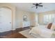 This main bedroom features a ceiling fan, light brown walls, and wood-look floors at 5243 E Windstone Trl, Cave Creek, AZ 85331
