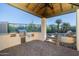 Covered outdoor kitchen and bar area with stainless steel grill, brick pavers, and access to the pool at 5243 E Windstone Trl, Cave Creek, AZ 85331