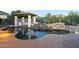 Beautiful backyard pool with waterfall feature, lush landscaping, and an outdoor kitchen at 5243 E Windstone Trl, Cave Creek, AZ 85331