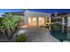 Lush landscaping surrounds a refreshing pool with a brick patio and covered terrace at 5243 E Windstone Trl, Cave Creek, AZ 85331