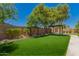 Manicured backyard with pergola, lush greenery, and privacy fence at 5312 S Hazelton Ln, Tempe, AZ 85283