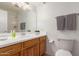 Bathroom featuring wood cabinets, double sinks, and a large mirror at 5312 S Hazelton Ln, Tempe, AZ 85283