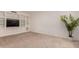 Neutral living room featuring built in shelving and storage, with natural light and a houseplant at 5312 S Hazelton Ln, Tempe, AZ 85283