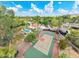 Lush neighborhood aerial shot featuring mature trees, sparkling pool and sport court at 5540 E Mercer Ln, Scottsdale, AZ 85254