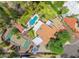 Stunning aerial view of the estate, showcasing a pool, tennis court, lush landscaping, and privacy at 5540 E Mercer Ln, Scottsdale, AZ 85254