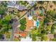 Aerial of lush neighborhood featuring multiple houses, mature trees, pools and sport courts at 5540 E Mercer Ln, Scottsdale, AZ 85254