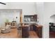 Cozy bar with wood counters, seating, and storage provides a place for refreshments and entertaining at 5540 E Mercer Ln, Scottsdale, AZ 85254