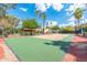 View of a basketball court surrounded by green landscaping and palm trees at 5540 E Mercer Ln, Scottsdale, AZ 85254