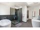 The bathroom offers a seamless glass shower, soaking tub, modern fixtures and stylish tile at 5540 E Mercer Ln, Scottsdale, AZ 85254