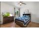 Bedroom features a ceiling fan, neutral walls, and a wooden bed frame with a decorative headboard at 5540 E Mercer Ln, Scottsdale, AZ 85254