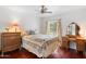 Charming bedroom features a vintage bedroom suite, hardwood floors and a ceiling fan at 5540 E Mercer Ln, Scottsdale, AZ 85254