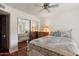 Bright bedroom with mirrored closet, ceiling fan and a full size bed with a colorful quilt at 5540 E Mercer Ln, Scottsdale, AZ 85254