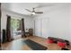Bedroom features a sliding closet, ceiling fan, and a workout area with yoga mat and weights at 5540 E Mercer Ln, Scottsdale, AZ 85254