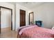 Bedroom with a wingback chair, a cozy throw blanket, and neutral paint and flooring at 5540 E Mercer Ln, Scottsdale, AZ 85254