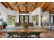 Dining area featuring natural light, wooden table with seating and a view of the outdoor pool at 5540 E Mercer Ln, Scottsdale, AZ 85254
