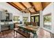 Dining area showcasing a wooden table with bench seating and an outdoor view of the swimming pool at 5540 E Mercer Ln, Scottsdale, AZ 85254