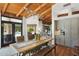 Open dining area with wooden table and chairs, pool view, and direct access to the kitchen at 5540 E Mercer Ln, Scottsdale, AZ 85254