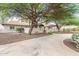 Charming front exterior showcases mature trees and a well-maintained yard at 5540 E Mercer Ln, Scottsdale, AZ 85254