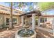 Charming water fountain feature enhances the curb appeal of this home's front exterior at 5540 E Mercer Ln, Scottsdale, AZ 85254
