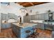 Spacious kitchen with a large island, custom cabinets, stainless steel appliances, and terra cotta flooring at 5540 E Mercer Ln, Scottsdale, AZ 85254