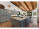 Open kitchen with a large island, custom cabinets, stainless steel appliances, and terra cotta flooring at 5540 E Mercer Ln, Scottsdale, AZ 85254