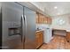 Spacious laundry room boasts stainless fridge, modern appliances, cabinets, and desk at 5540 E Mercer Ln, Scottsdale, AZ 85254